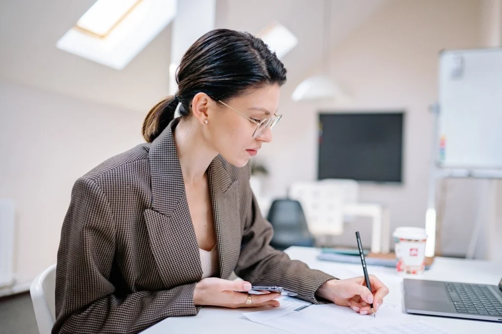 Administrative VA taking notes in office with pencil in hand